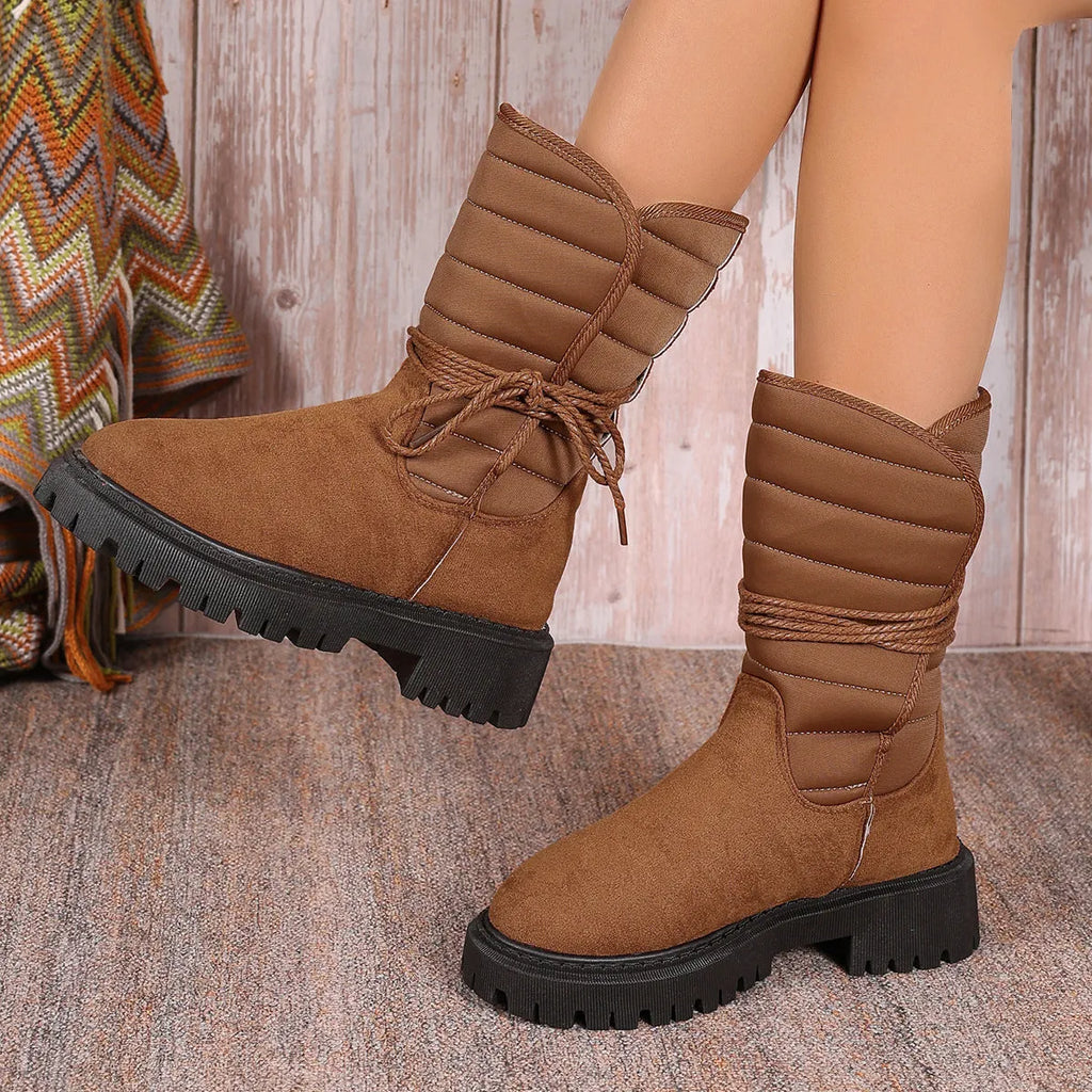 Women's black chunky heel snow boots with lace-up front and fleece lining on a white background.