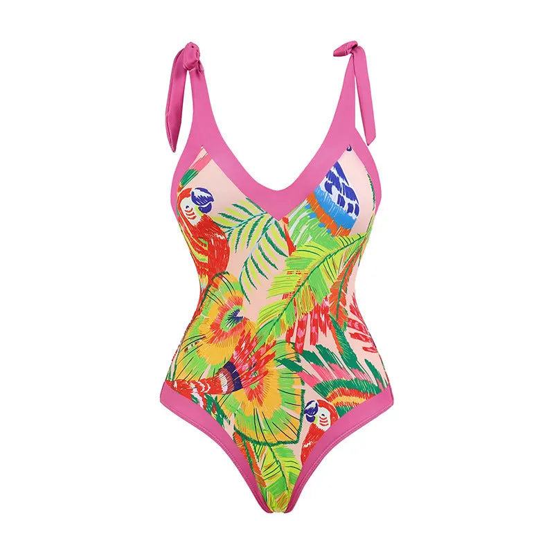 Pink floral retro one-piece swimsuit for women with V-neck and attached skirt on a hanger.