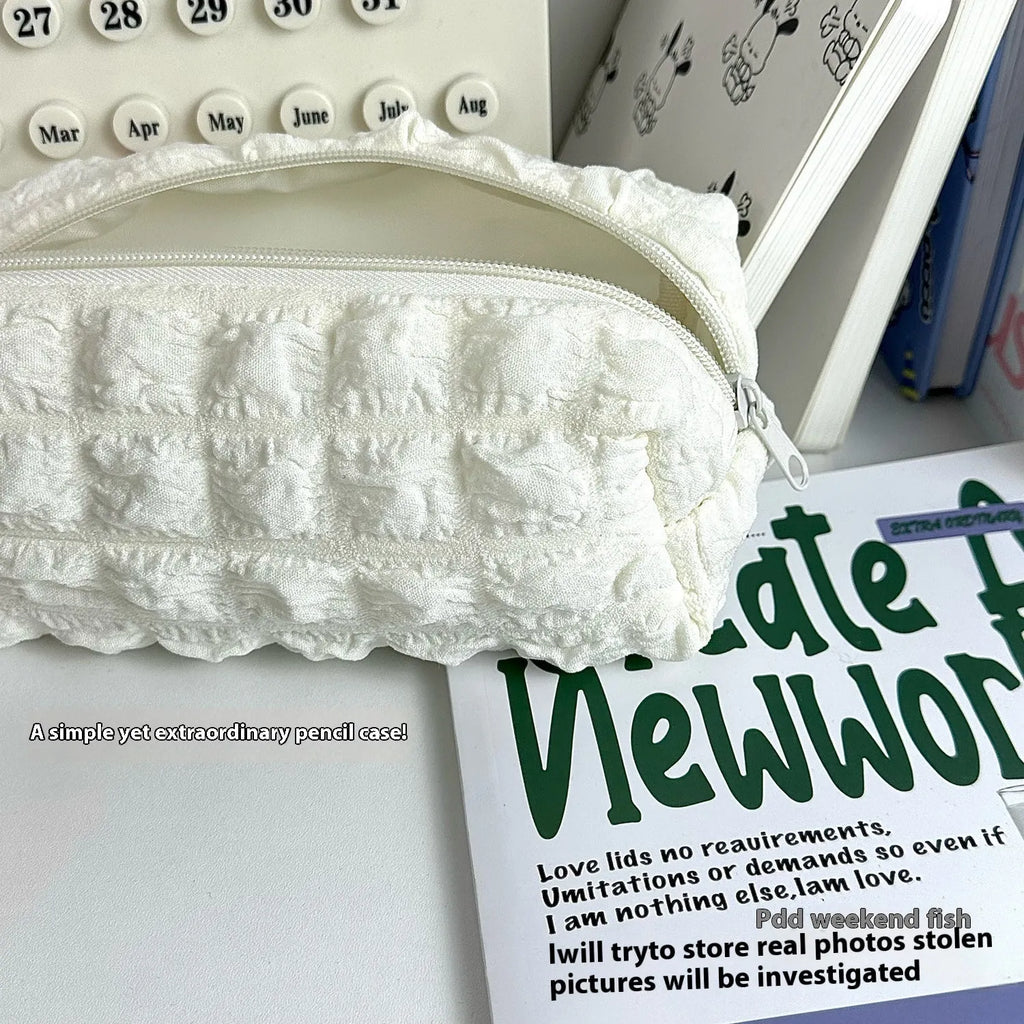 Cream puff style fabric pencil case in beige colour with zippered closure