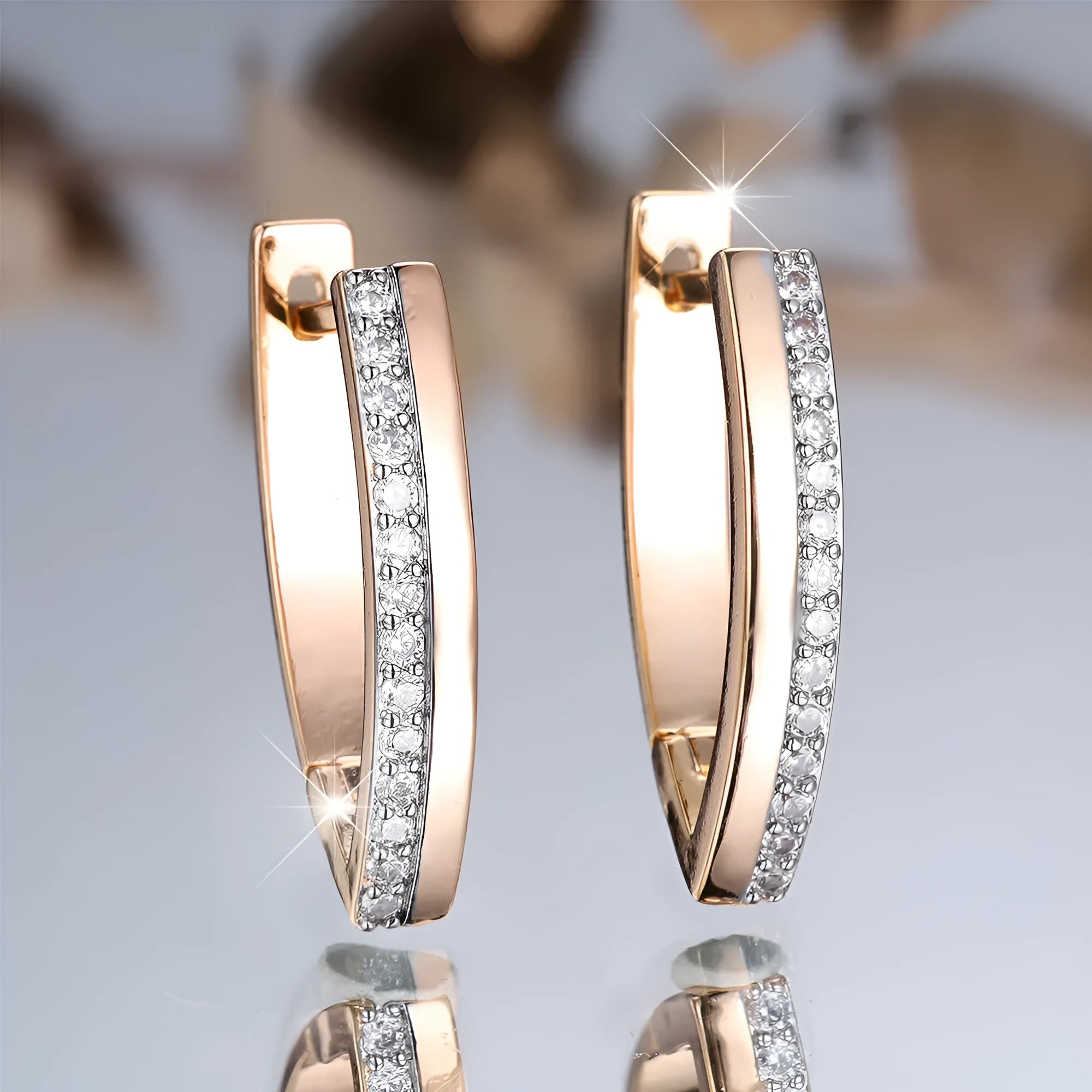 Geometric V-shaped women's earrings in champagne gold white diamond colour.