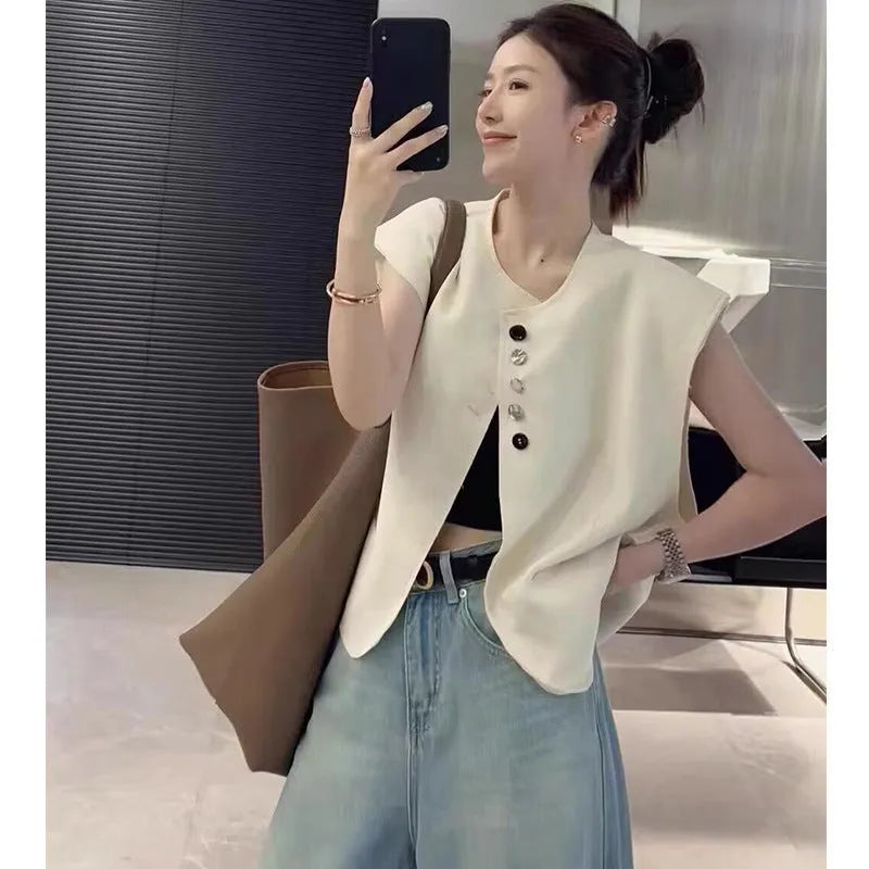 Women's loose fit polyester vest in milky white colour with pockets, shown on hanger