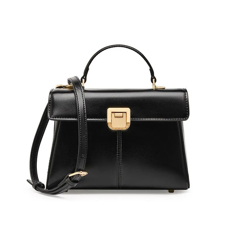 Black leather women's shoulder bag with vachette clasp showing horizontal square shape and adjustable strap