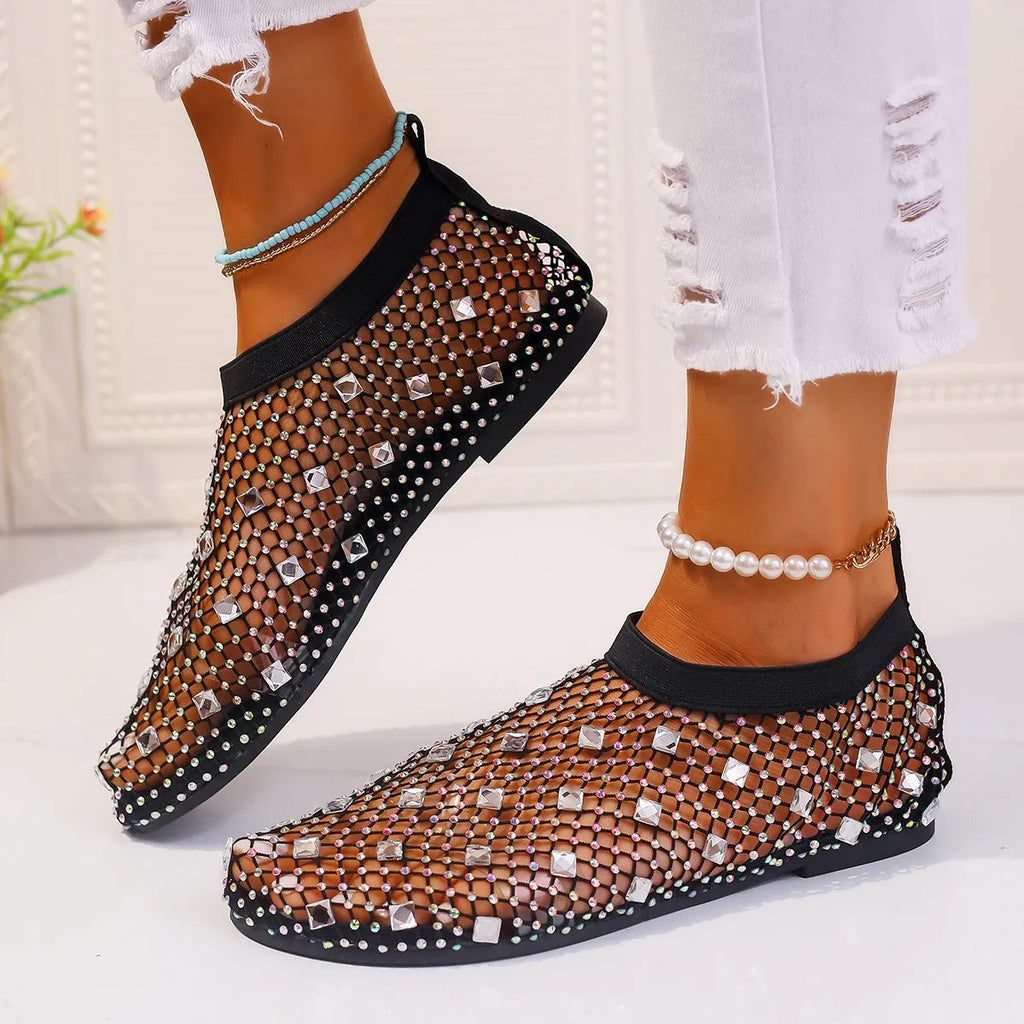 Women's flat sandals with mesh upper, colourful rhinestone detail, and a round toe.