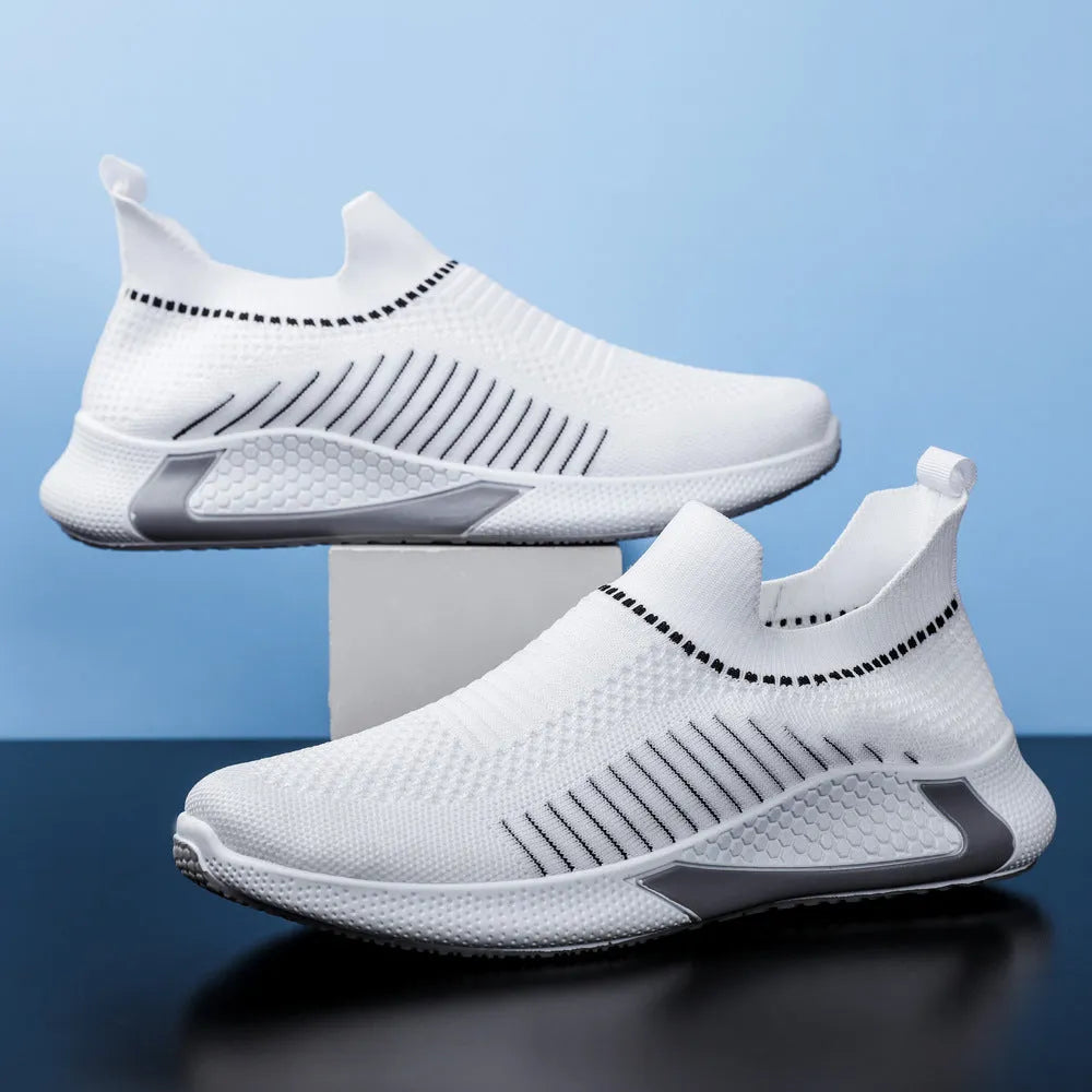 Men's black and white striped mesh slip-on sneakers with lace-up front on a plain background.