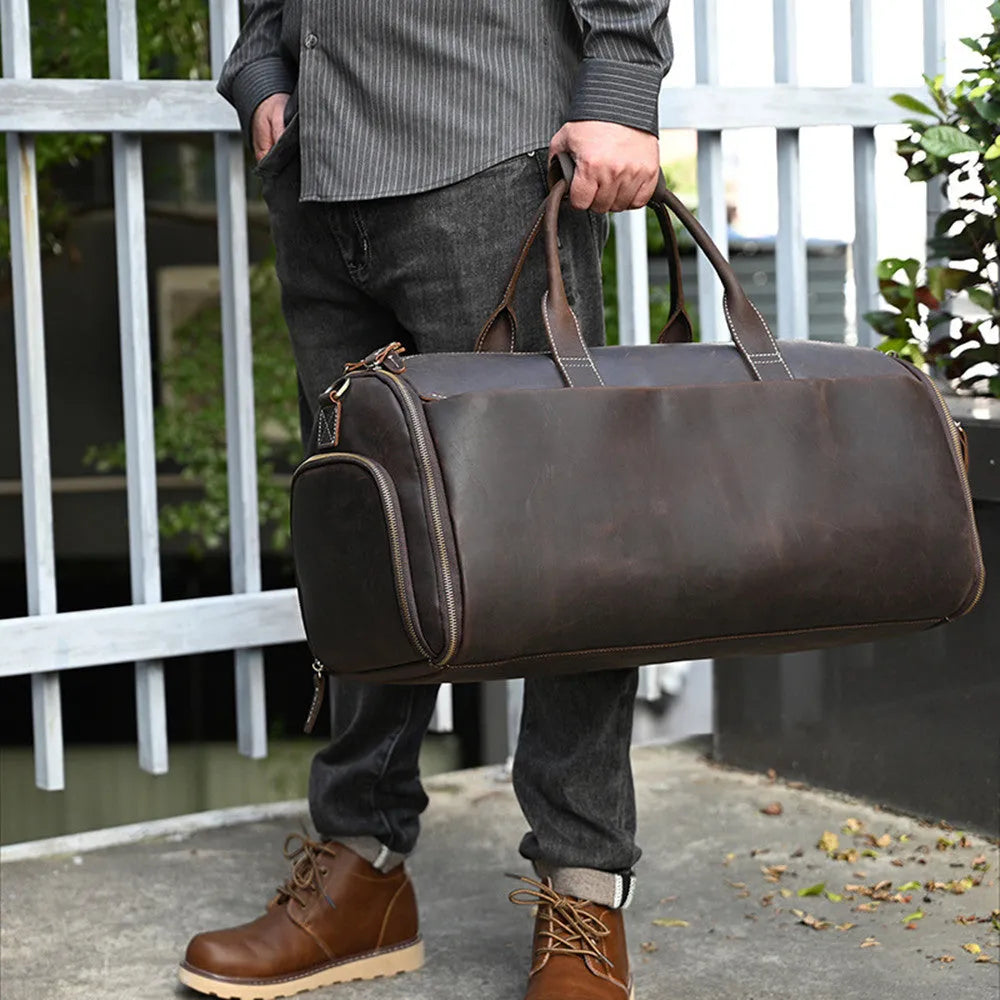 Vintage 22 inch brown leather duffle bag made from top layer cowhide, folding design with zipper closure on plain background