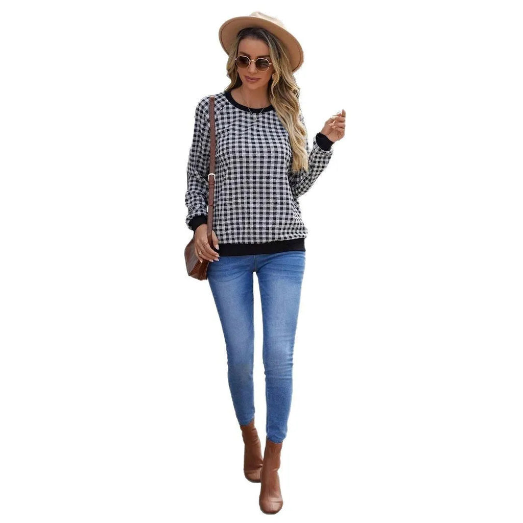 Black long sleeve plaid pullover sweater with Japanese style printing laid flat.