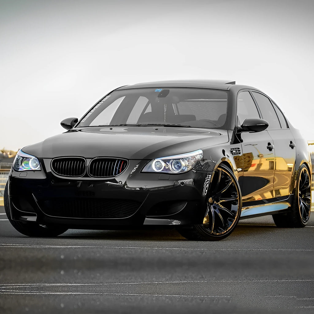 Pair of black carbon fibre pattern front grilles for a BMW 5-Series car.