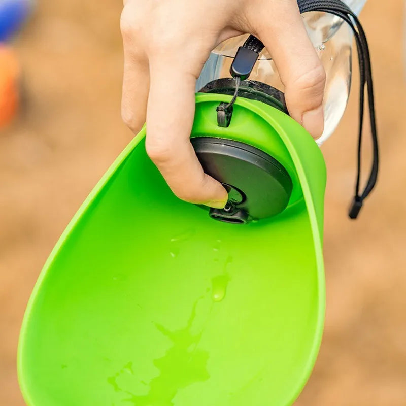 Portable blue pet drinking water bottle with attached bowl and carabiner clip for outdoor use