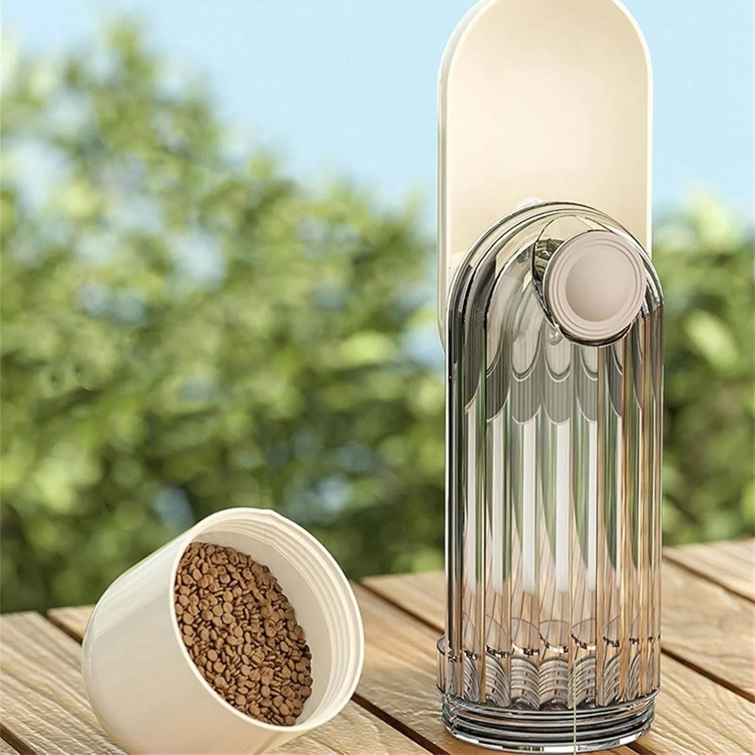 Beige foldable dog water bottle with integrated food container, shown with press-button tray.