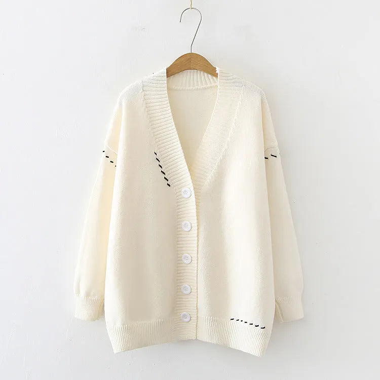 Women's loose black knitted cardigan with long sleeves on hanger