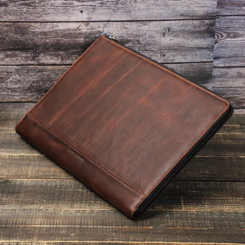 Crazy Horse oil leather zipper laptop bag in coffee colour on a wooden surface
