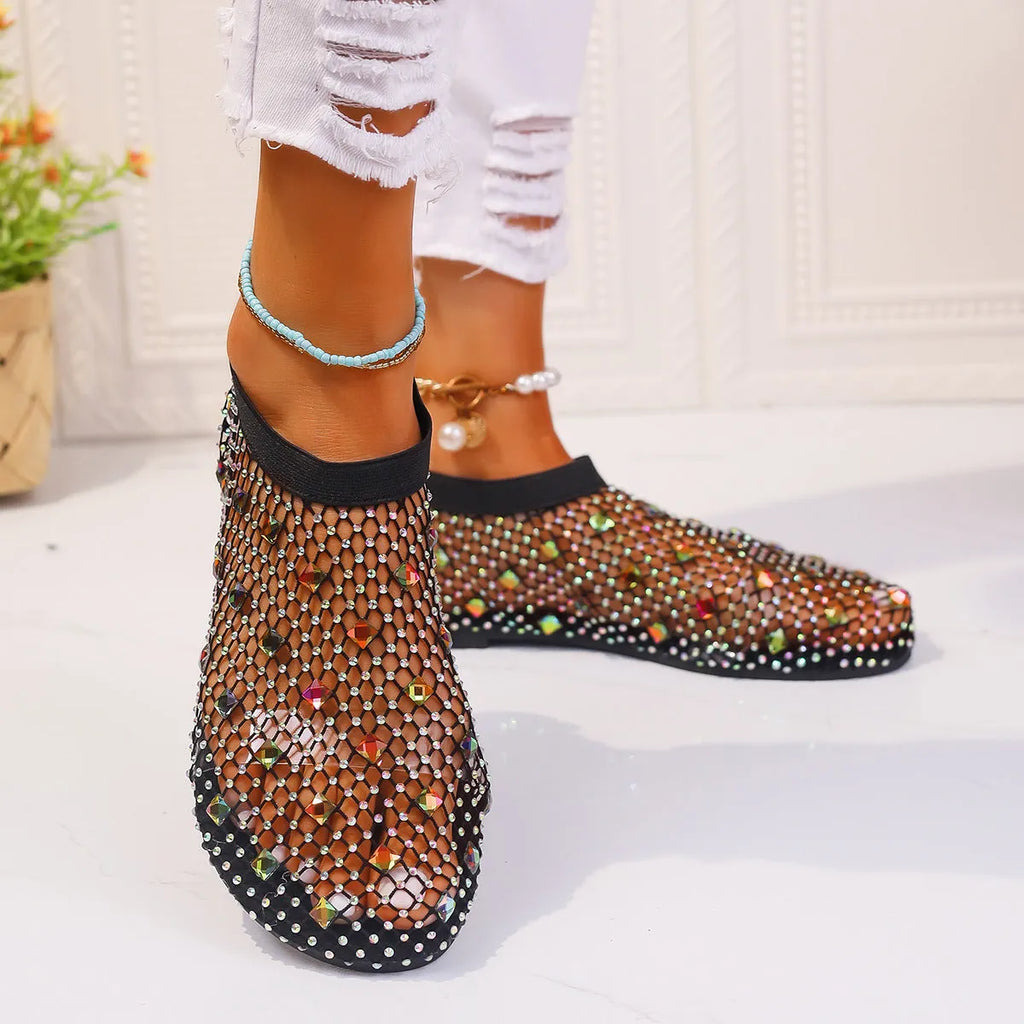 Women's flat sandals with mesh upper, colourful rhinestone detail, and a round toe.