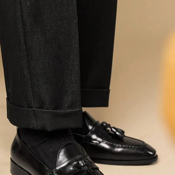 Men's genuine leather tassel loafers in black and brown colours showing polished uppers and rubber soles