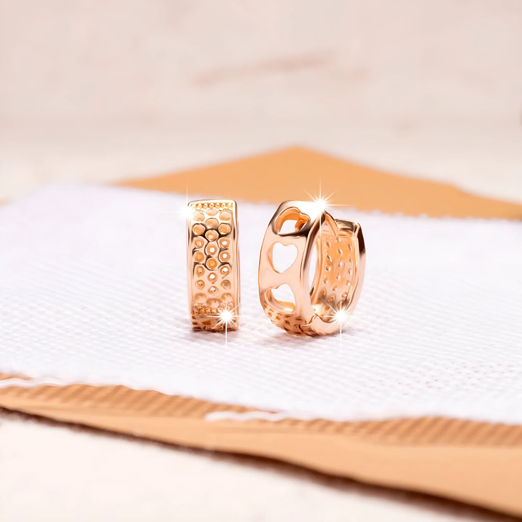 Rose gold hollow heart earrings with three open sections and circular shape