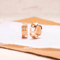 Rose gold hollow heart earrings with three open sections and circular shape