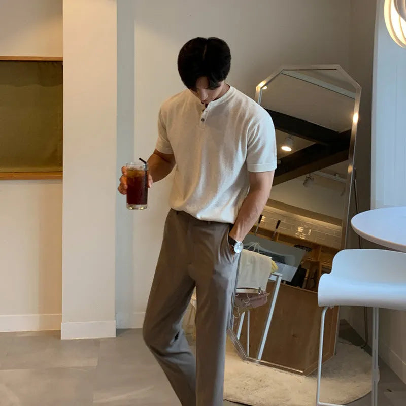 Man wearing a thin black short-sleeved ice silk knitted pullover shirt with a slim loose fit.