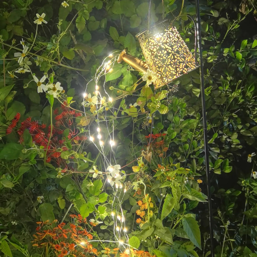 Solar-powered wrought iron butterfly kettle light for outdoor garden decoration.