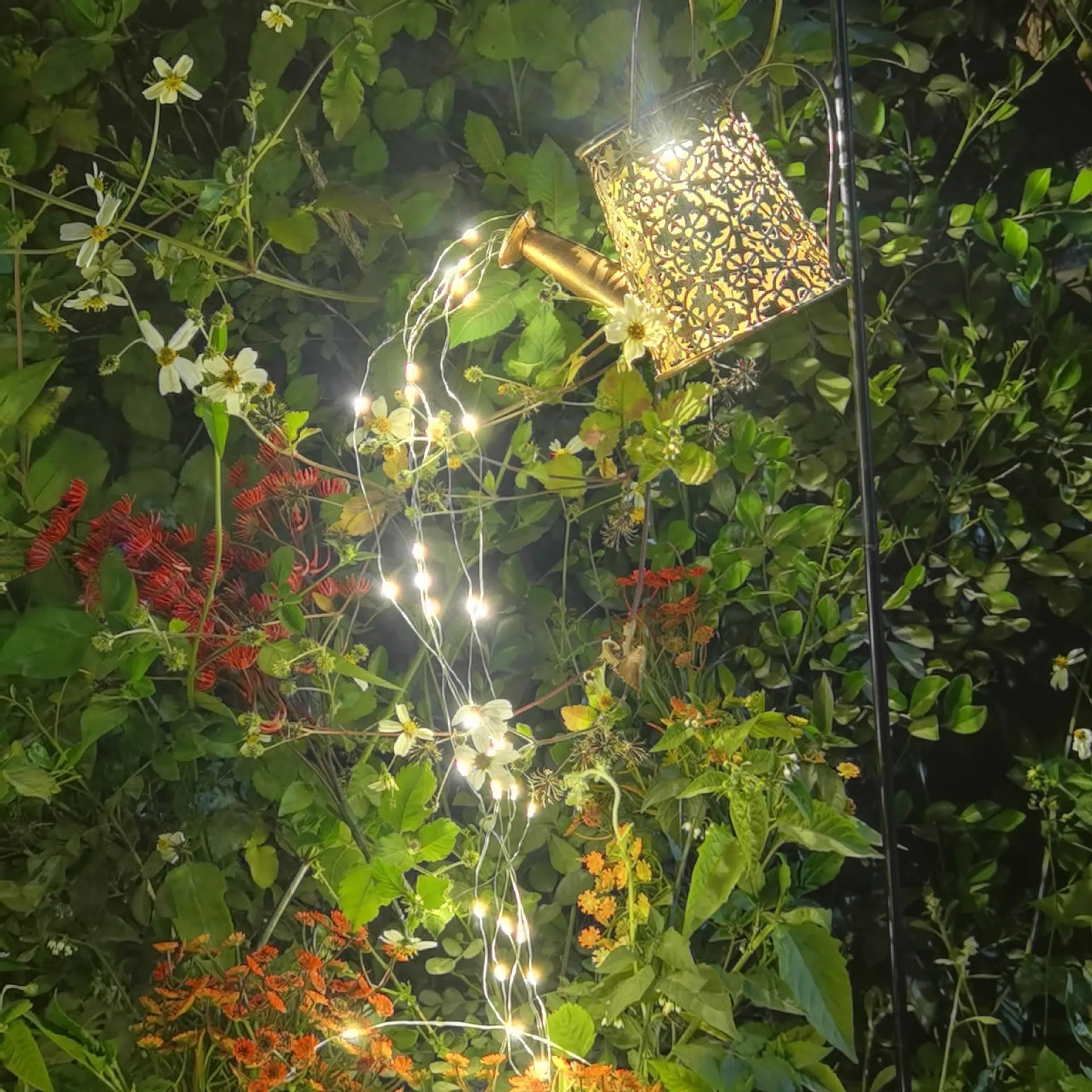 Solar-powered wrought iron butterfly kettle light for outdoor garden decoration.