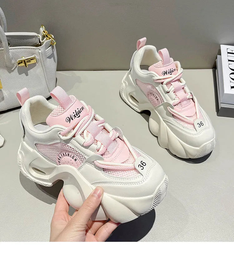 Women's pink casual sneakers with cross shoulder straps and a thick platform sole.