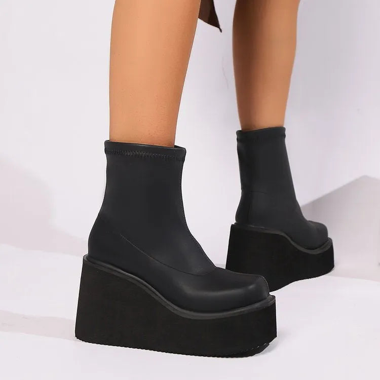 Plus size women's black wedge heel boot with a round toe and waterproof platform sole.