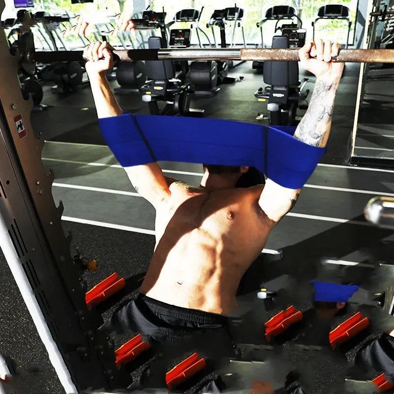 Elastic elbow support bandage in black, shown wrapped around an elbow, for boxing and exercise.