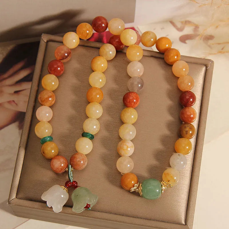 Women's natural jade multi-layer bracelet with orchid pendant detailing and jinsi construction