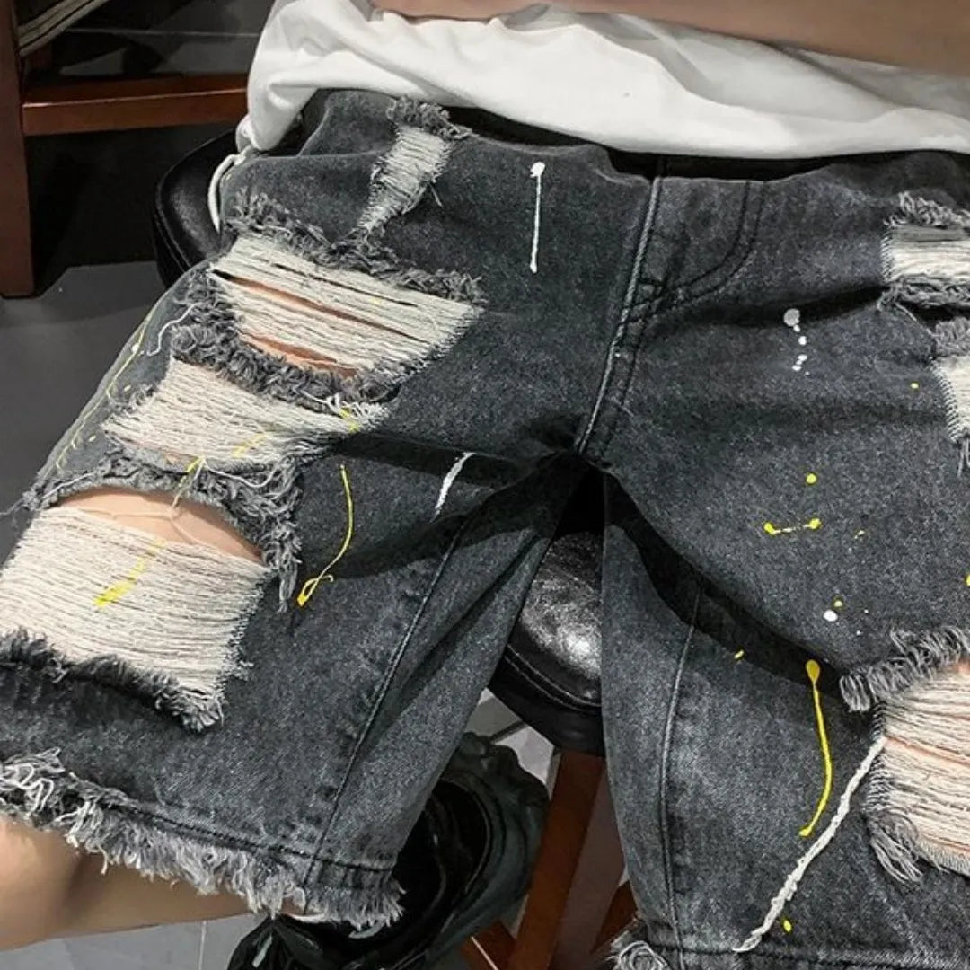 Men's loose-fit denim shorts with water-washed finish and distressed hole detailing in black colour
