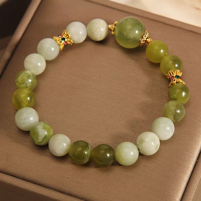 Original design women's bracelet with a single green Xiuyan jade stone in a Mori style.