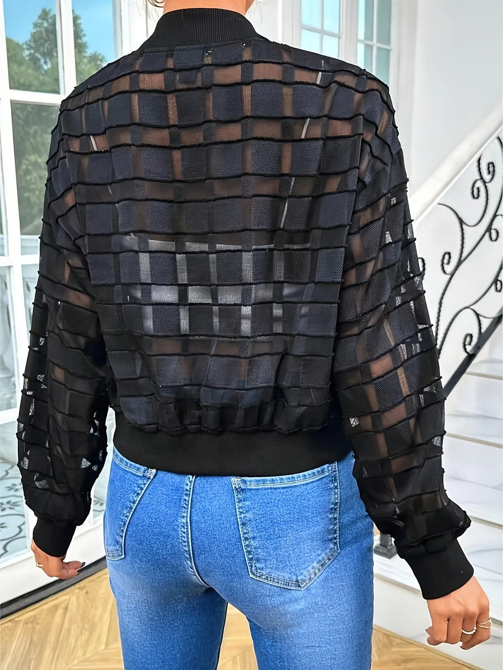 Black semi-transparent women's jacket with geometric pattern, thread zipper, and long sleeves.