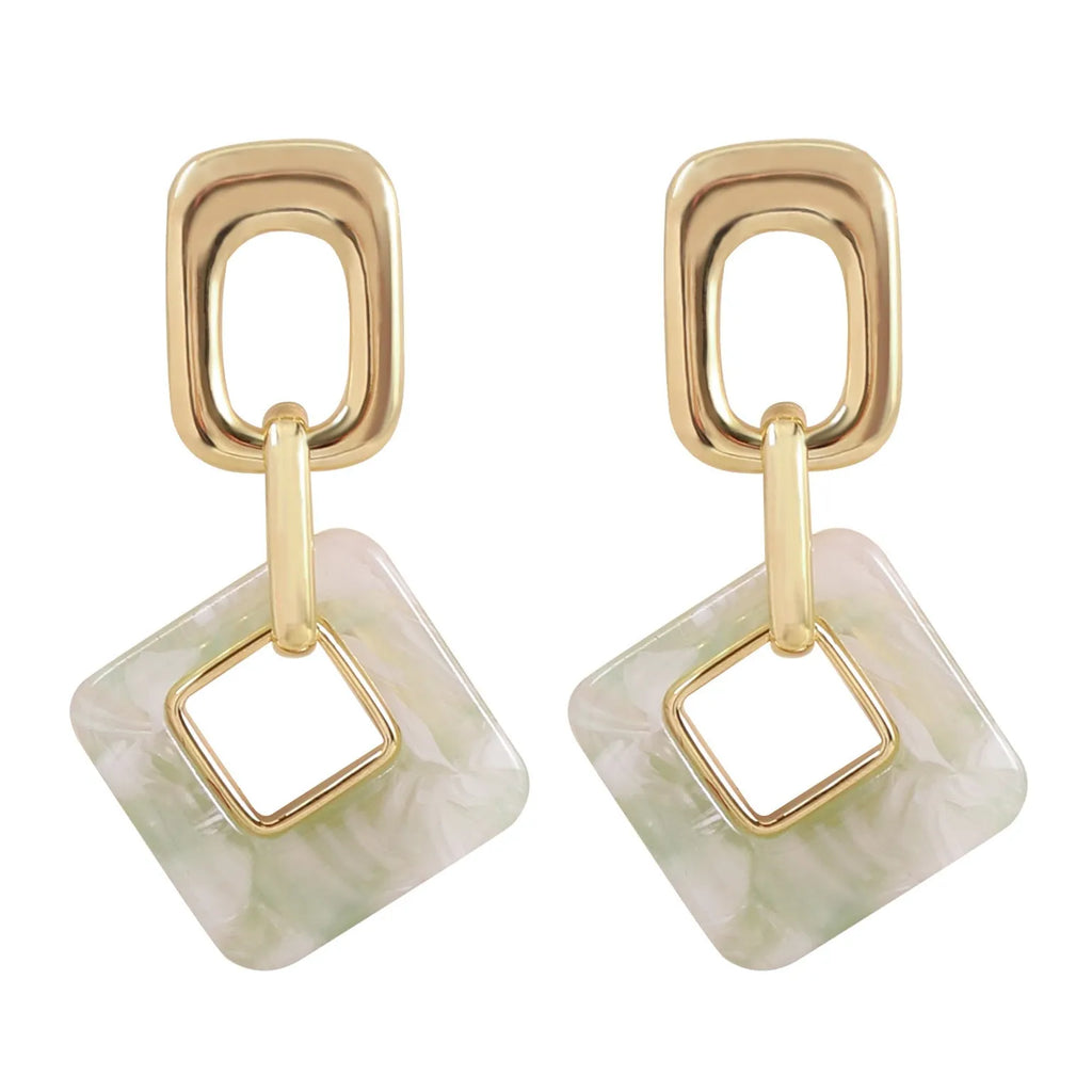 Pair of hollow geometric square copper earrings with chamfered corners in silver tone finish.