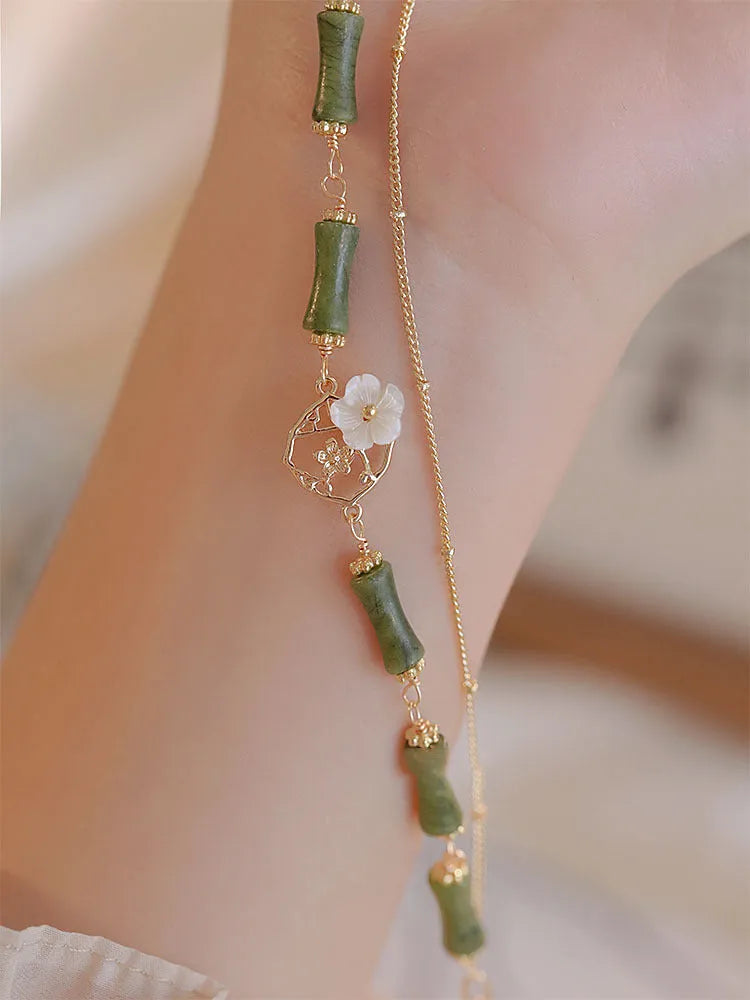Handmade natural olivine women's bracelet with Chinese double layer twin bells and an olive branch design.