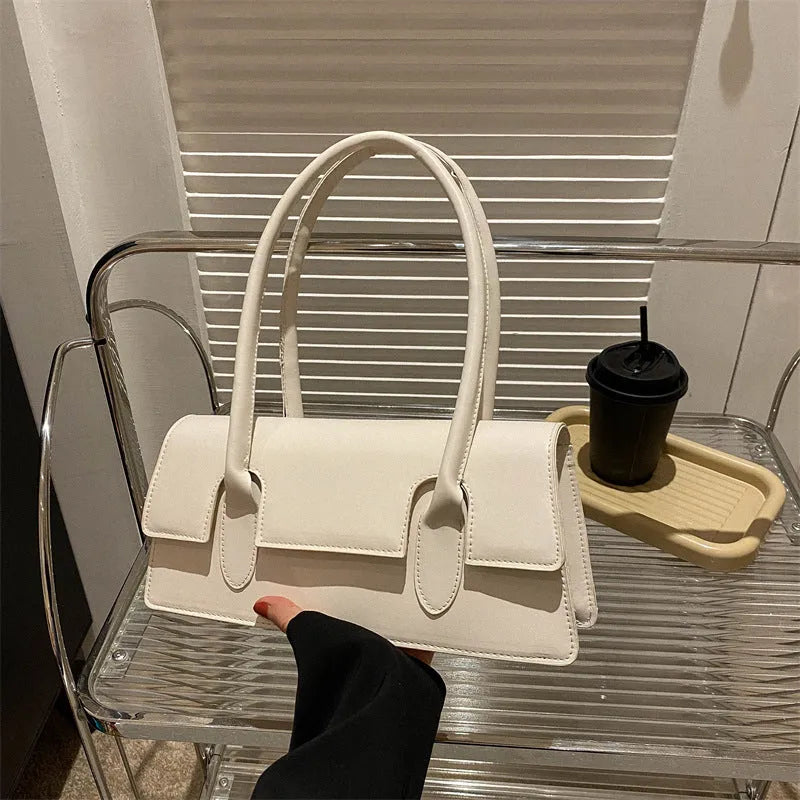 Women's small square shoulder bag in PU material showing stitching details and horizontal shape