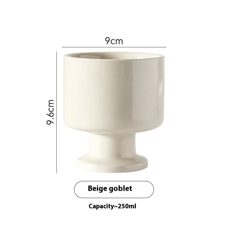 Hand-pinched ceramic mug with irregular shape and solid-colour finish, approximately 14.5cm tall