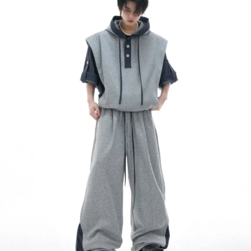 Men's black polyester hooded jacket with three-dimensional stitching on sleeves, paired with matching trousers