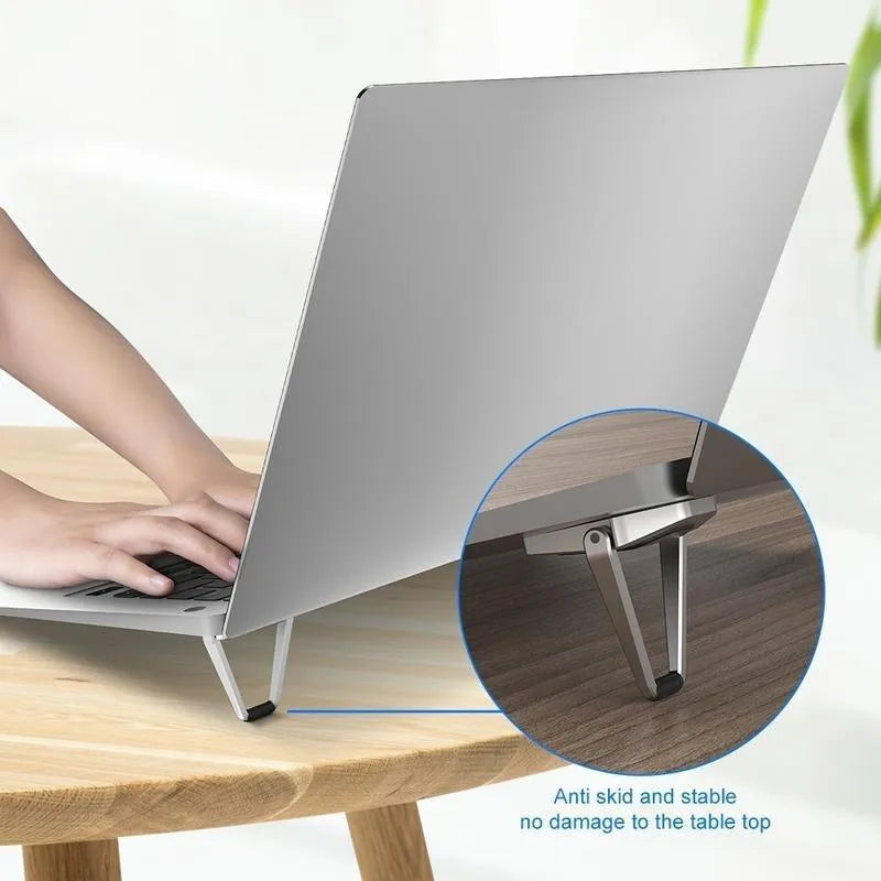 Compact silver aluminium folding laptop stand bracket shown next to 3M adhesive pads.