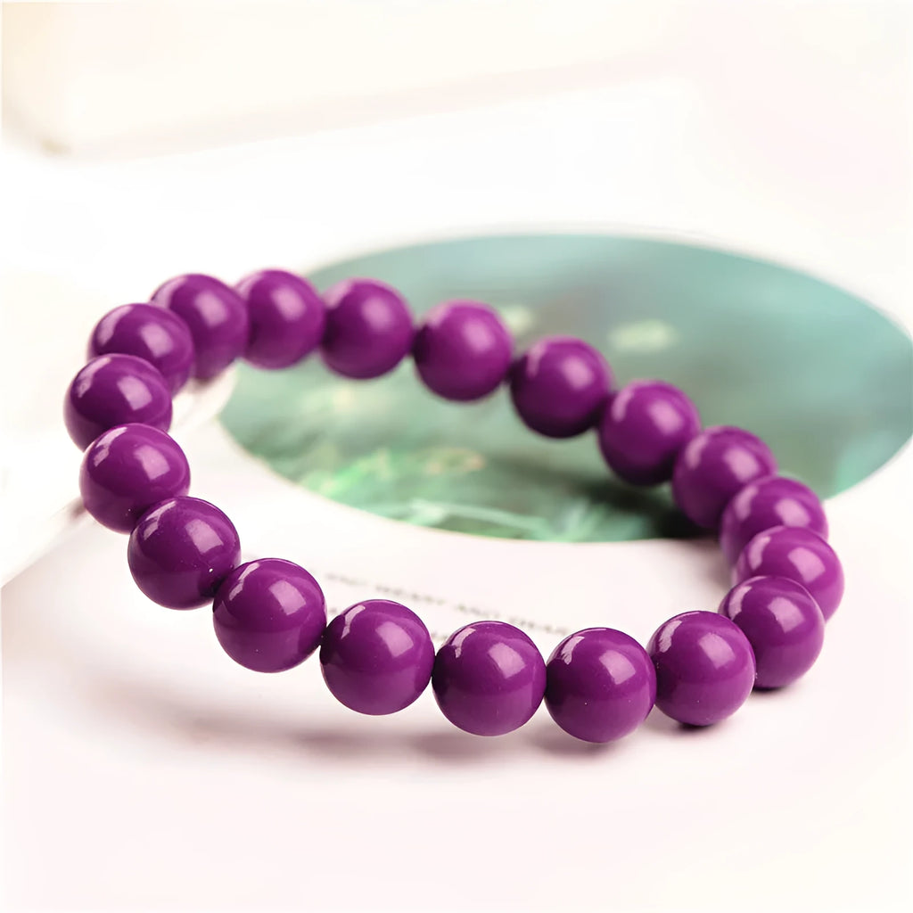 Polished purple mica crystal unisex bracelet in a single ring design on a white background.