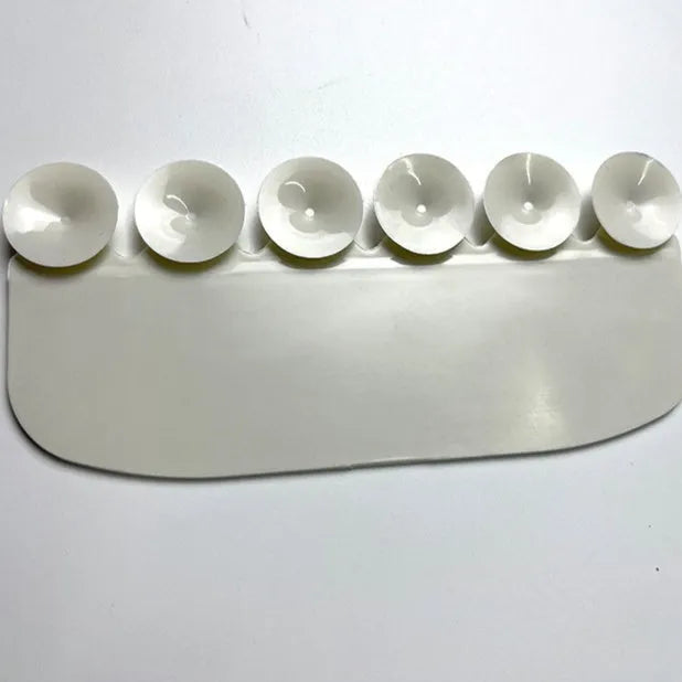 White PVC toilet urine blocking board placed on standard toilet seat