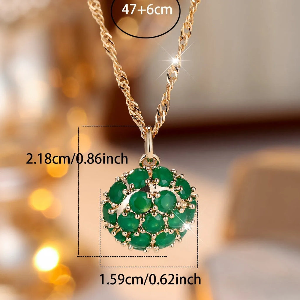 Round pendant necklace with emerald diamond elements on champagne gold electroplated chain