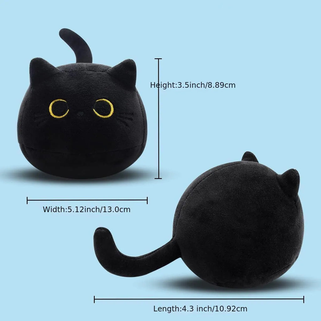 Fluffy black cat plush toy with embroidered face on a soft cushion
