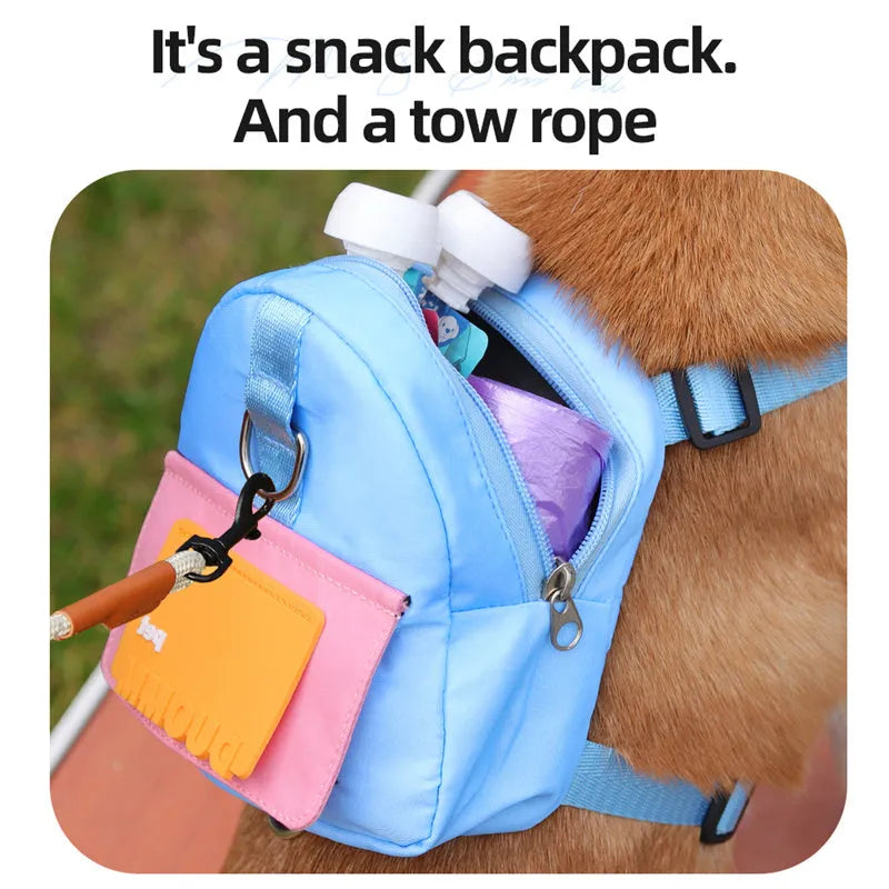 Blue adjustable dog backpack harness with storage pockets and a built-in tow rope laid flat.