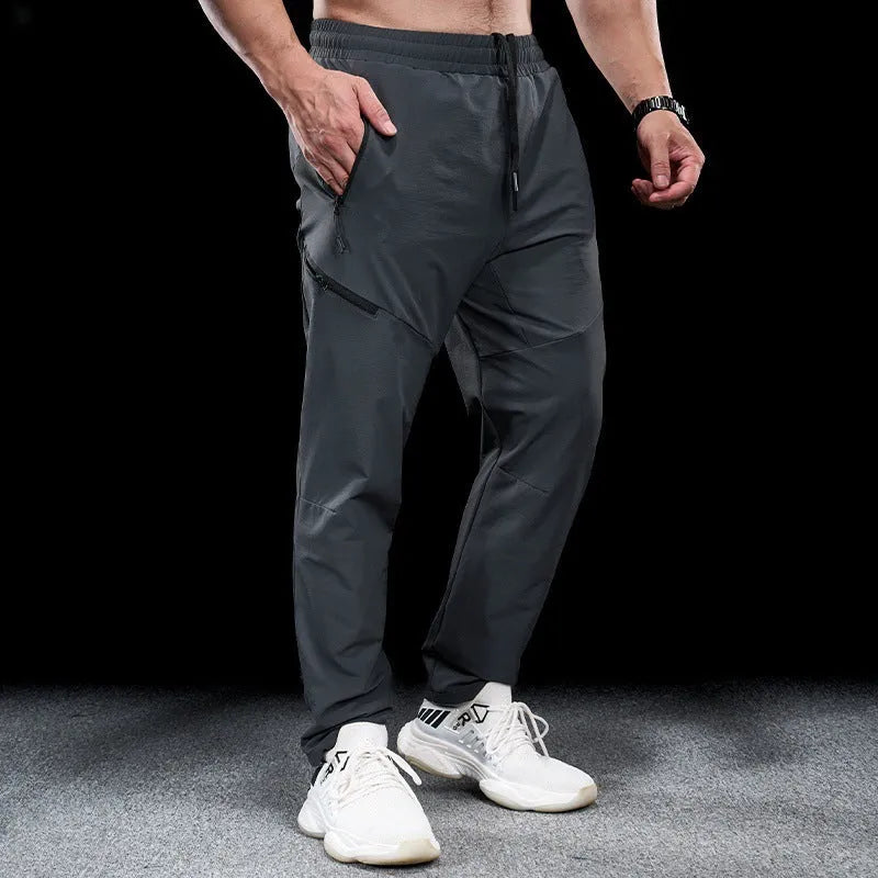 Men's black waterproof quick-drying workout pants with mid waist design for sports and fitness
