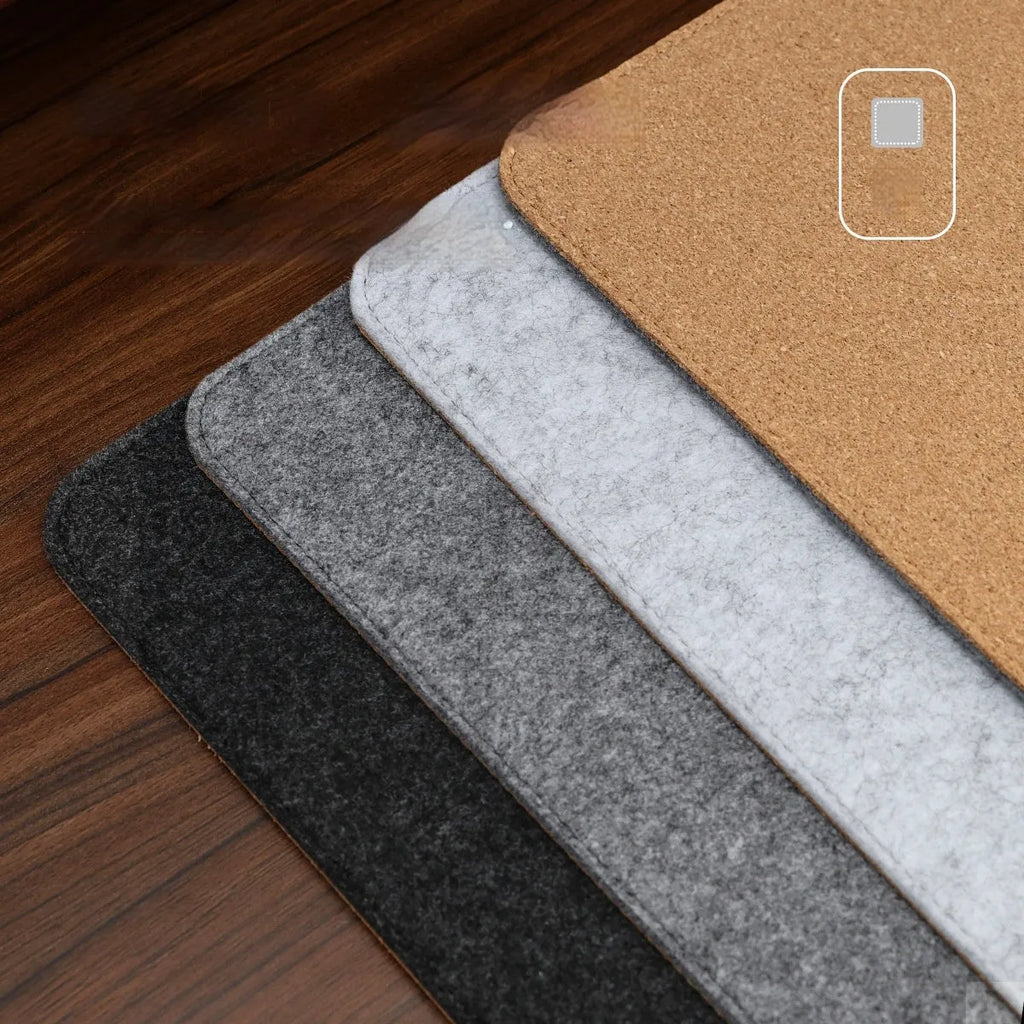 Simple grey felt and cork desk mat in an oversized rectangle shape on a wooden desk.