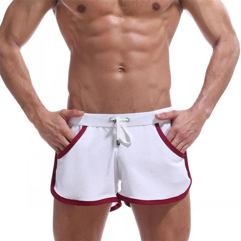 Summer men's quick-dry polyester sports shorts in multiple colours including black, green, and red for beach and casual wear.