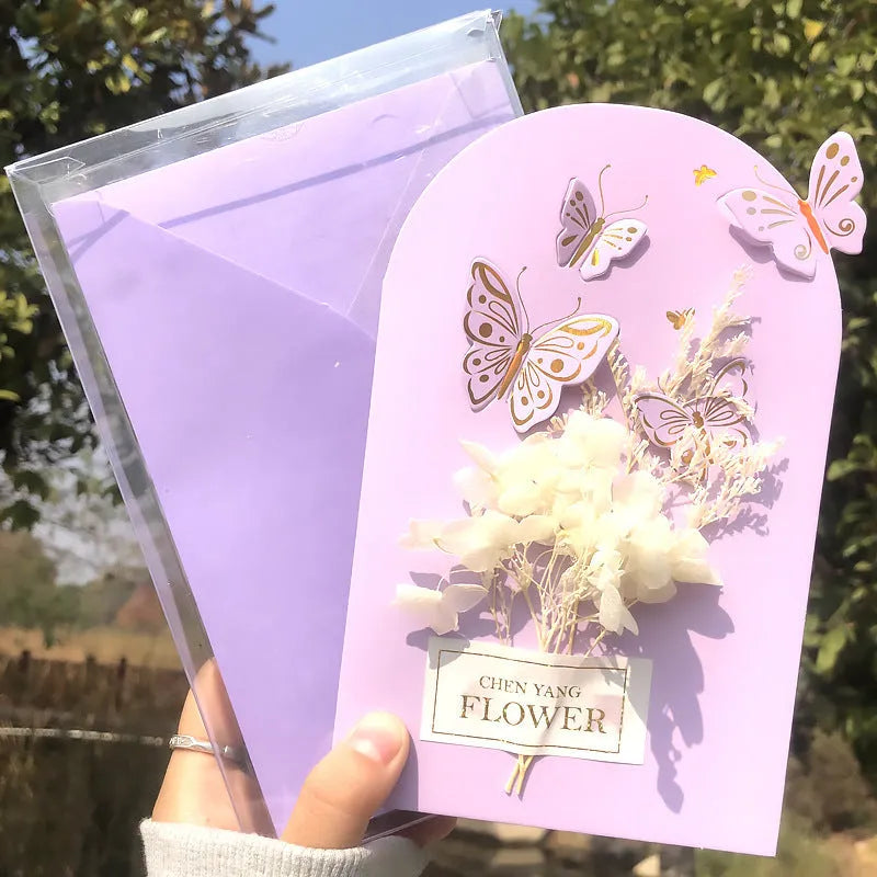 Handmade 3D butterfly-shaped birthday card with artificial flowers and hot foil stamping details.