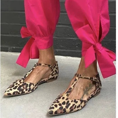 Leopard print women's pumps with pointed toe, chunky low heel, and ankle strap.