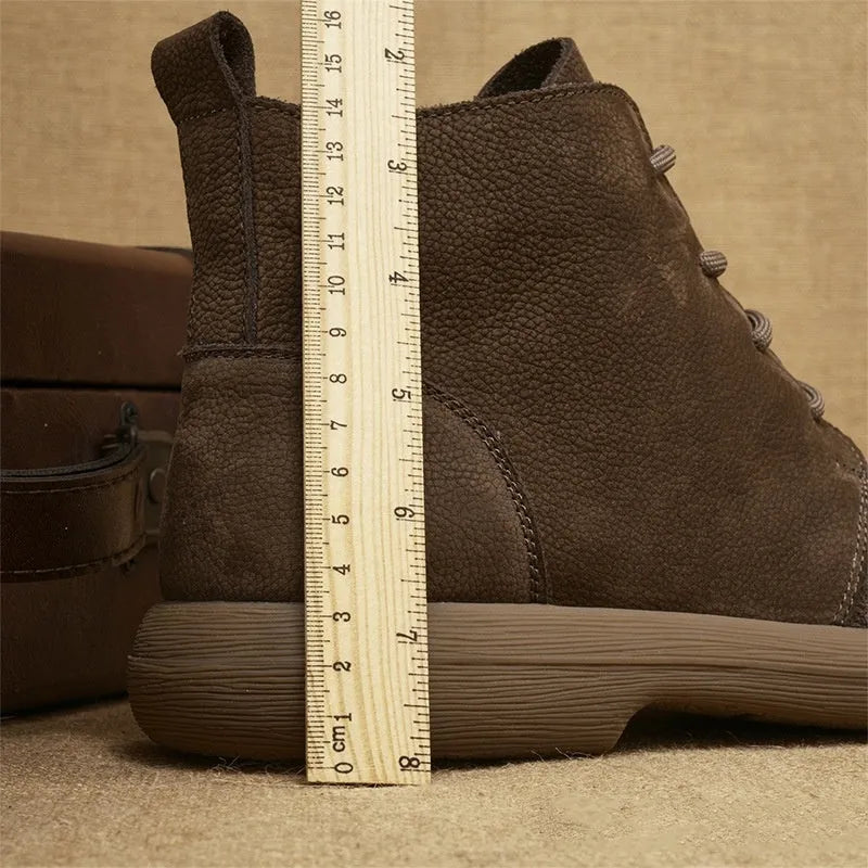 Grey genuine leather mid-calf lace-up boots with a wedge heel on a plain background.