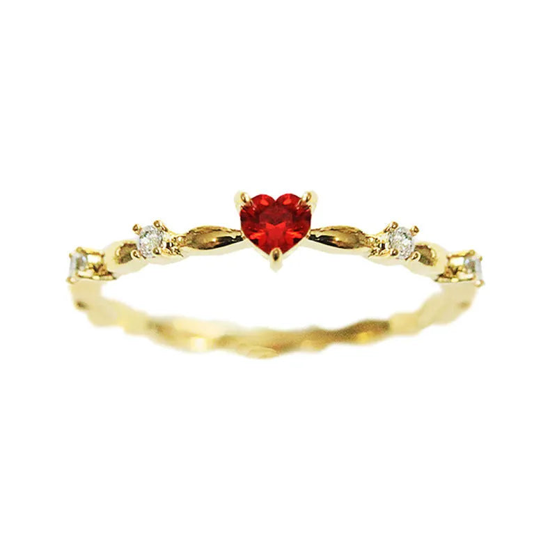 Gold electroplated copper ring with a peach heart charm and set zircon stone.