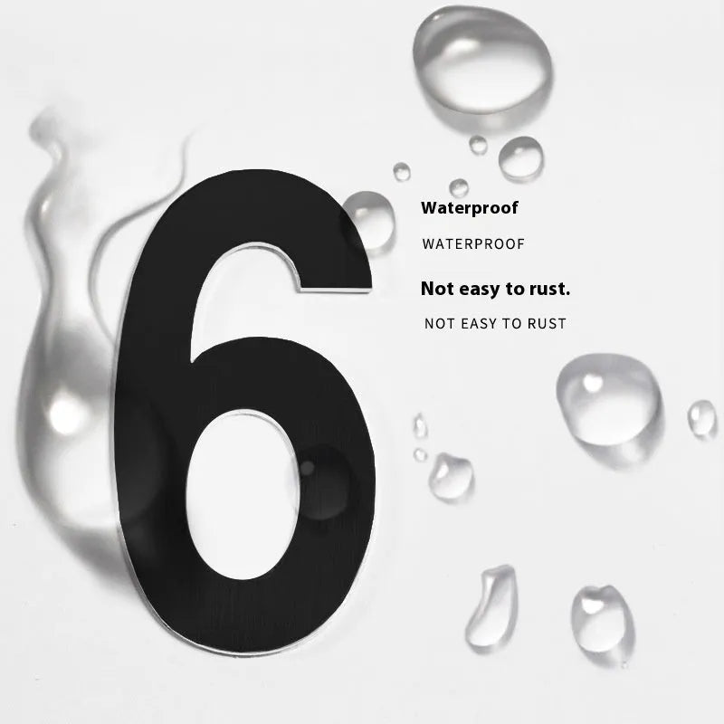 Black stainless steel adhesive house number sign showing digit 7, 7.5cm tall on adhesive backing.