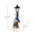 Solar hexagonal garden lamp with resin sculpture decoration in garden setting