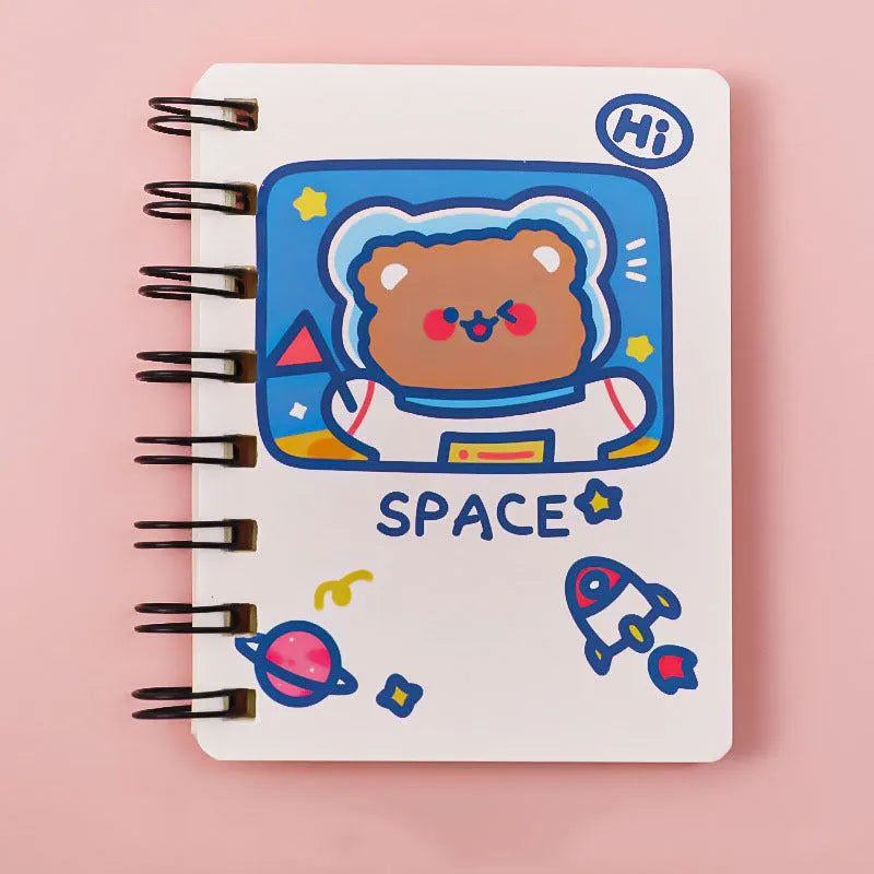 Small astronaut-themed flipper notebook showing one of four cover designs: Astronaut Bear, Planet Teddy, Space Cat, or UFO.
